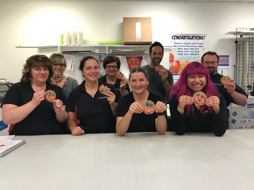 The team of FASTSIGNS Windsor supporting – and enjoying – Tim Horton’s Smile Cookie campaign.